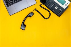Telephone -laptop -flat -lay -with -workspace -yellow -background